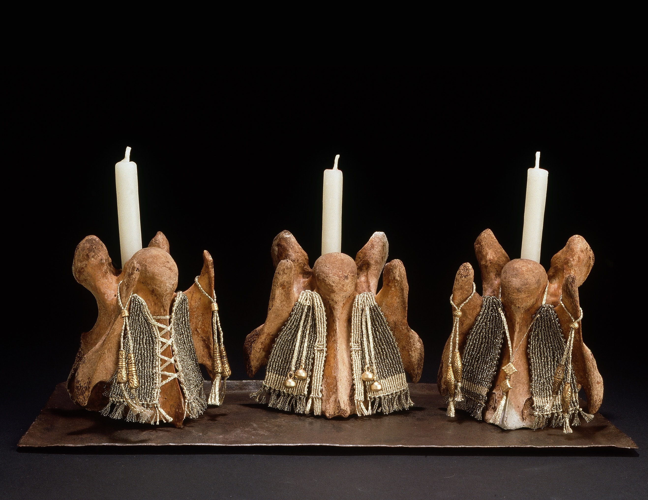 A Choir of Angels — three bone sculptures with beaded vestments and candles